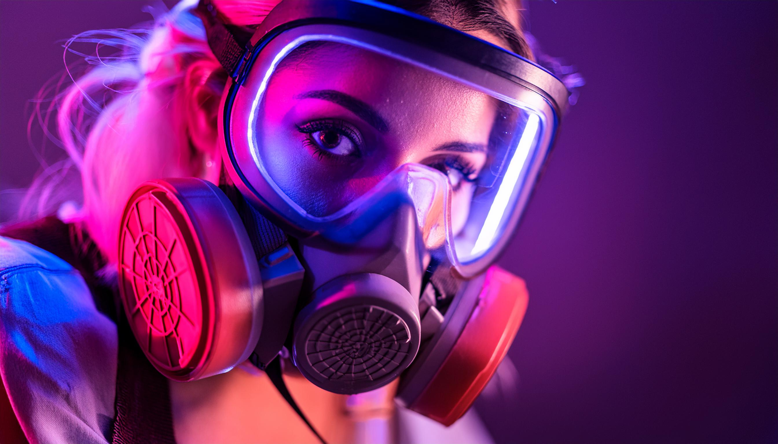 Woman wearing half-face supplied air respirator with protective eye safety equipment